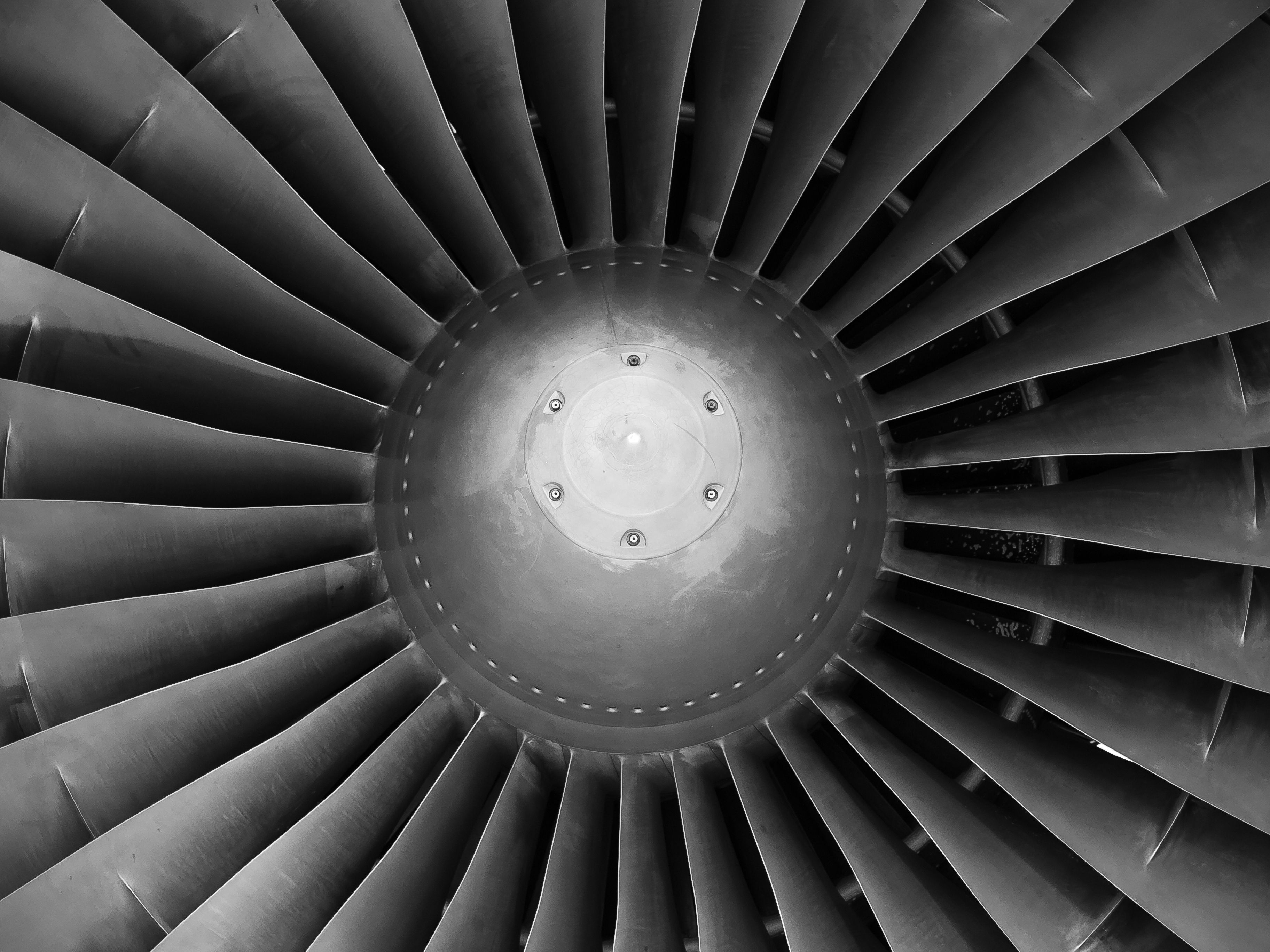 Close-up of a jet engine turbine fan, black and white